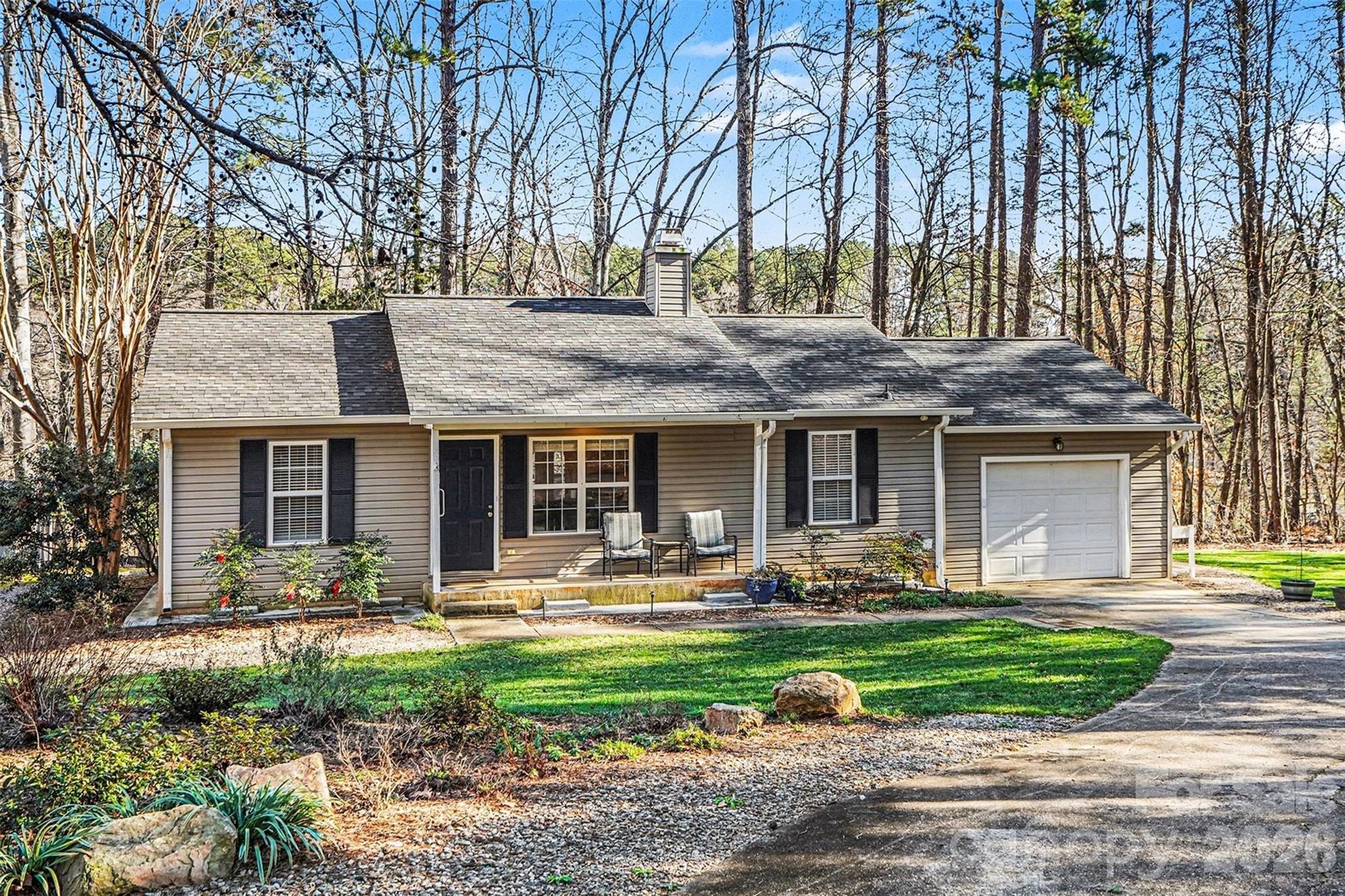 228 Creek View Road Mooresville, NC 28117 - Photo 24 of 40 a front view of a house with garden and trees