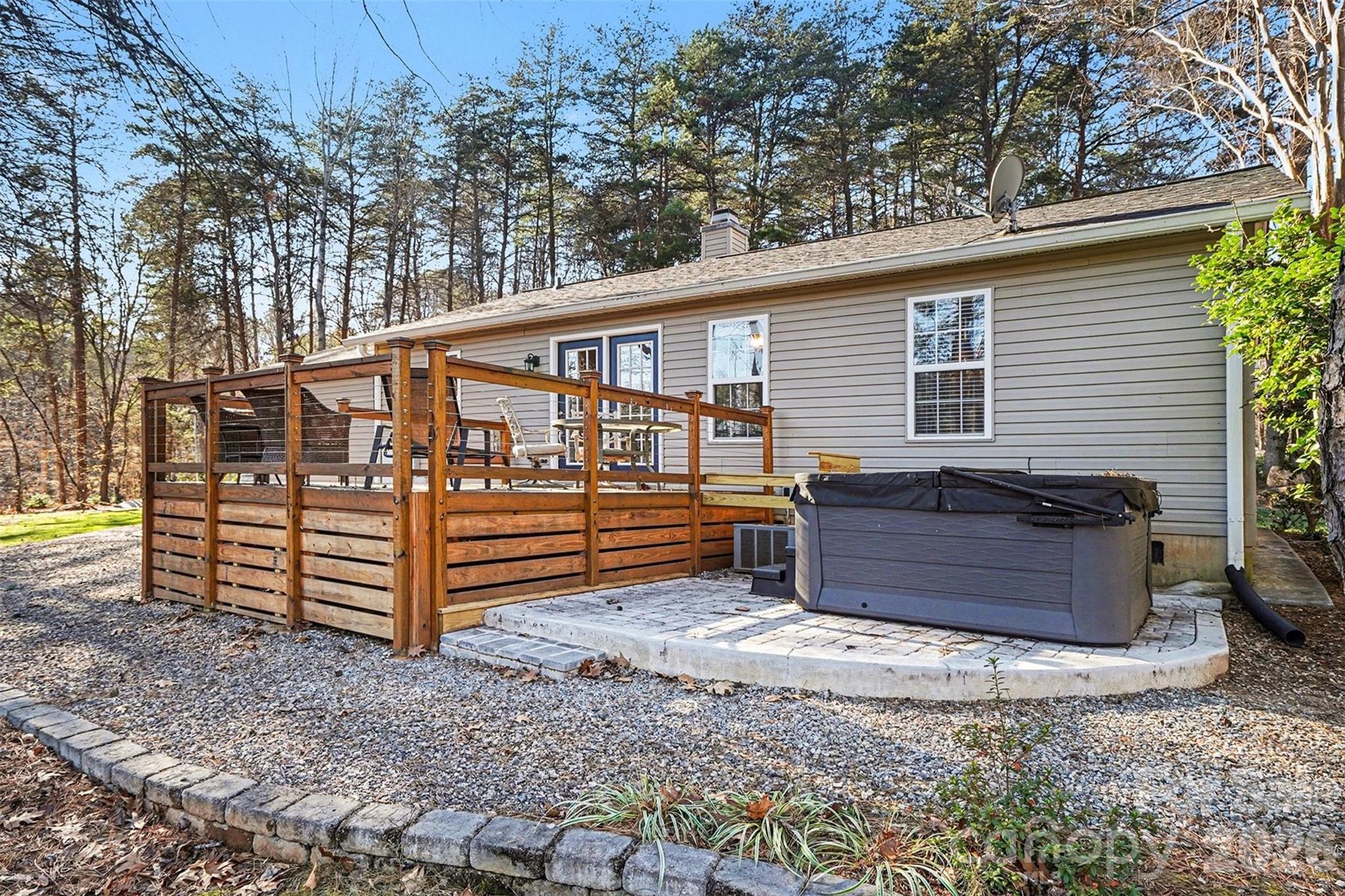 228 Creek View Road Mooresville, NC 28117 - Photo 27 of 40 a view of a house with a large window and wooden fence