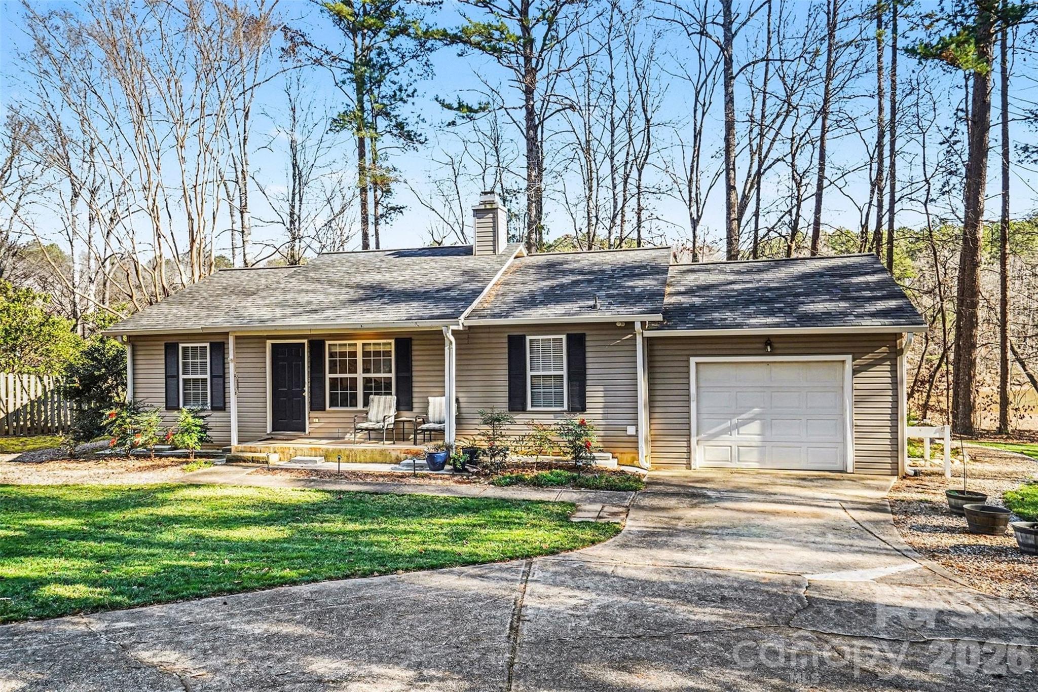 228 Creek View Road Mooresville, NC 28117 - Photo 30 of 40 a front view of a house with garden and trees