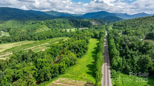 a view of a lush green hillside and a building