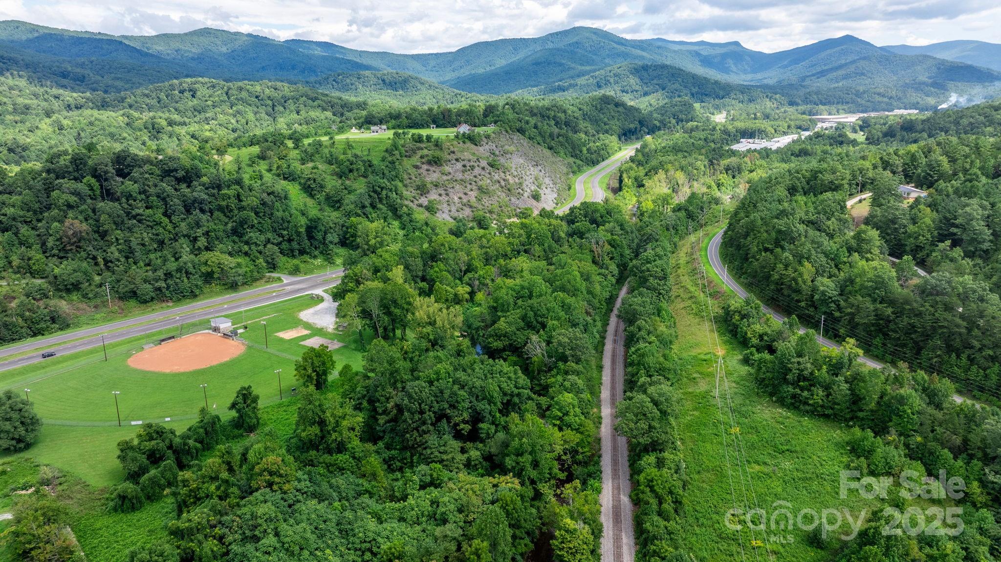 0 Old Linville Road Marion, NC 28752 - Photo 30 of 32 a view of a lush green forest with trees and some houses