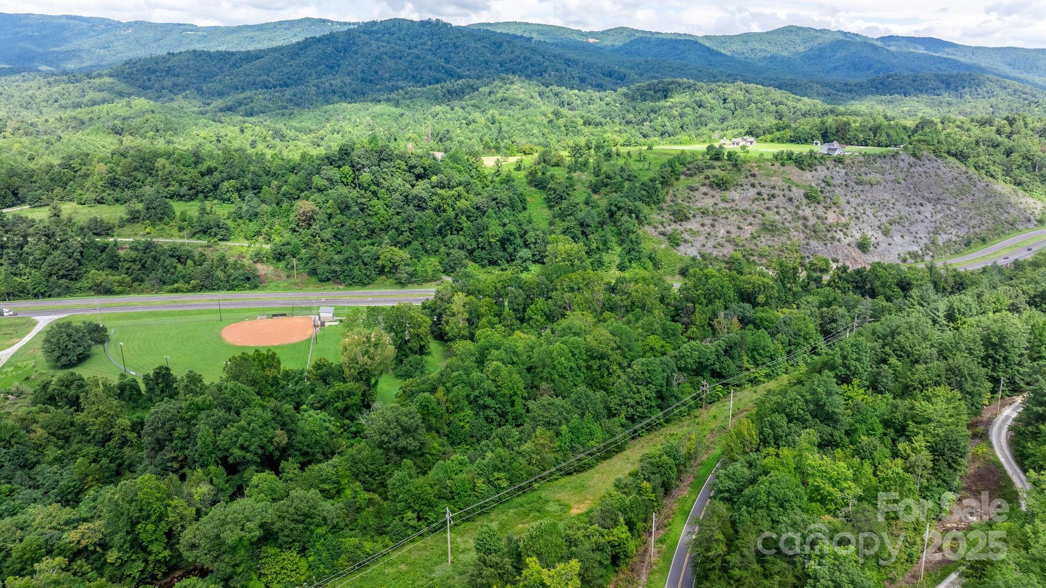 0 Old Linville Road Marion, NC 28752 - Photo 31 of 32 a view of a lush green hillside and a houses