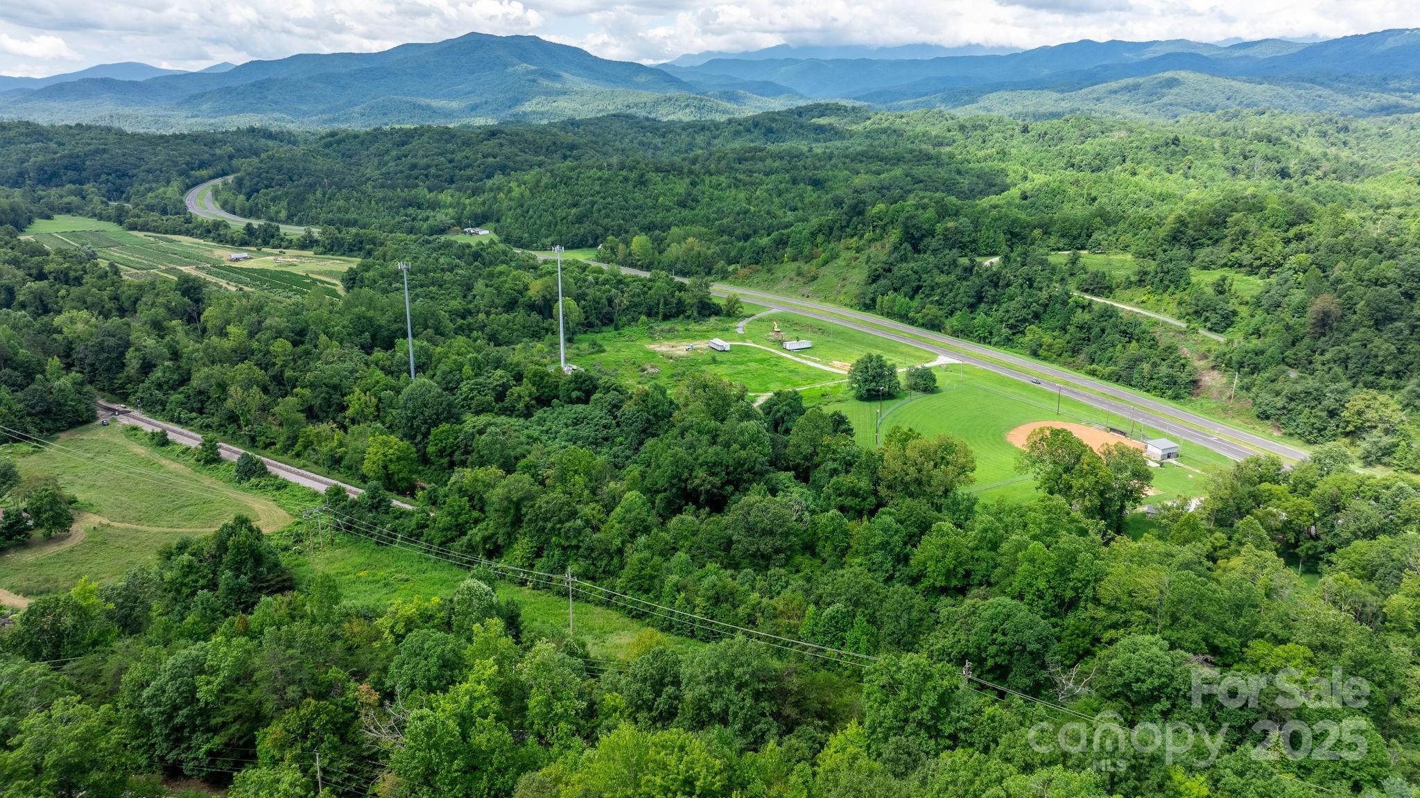 0 Old Linville Road Marion, NC 28752 - Photo 32 of 32 a view of a lush green forest with trees and some houses