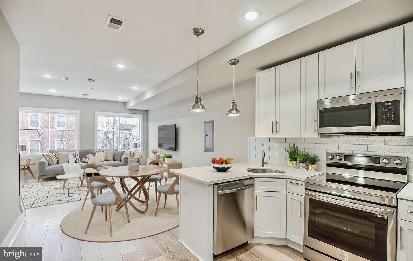 a kitchen with a stove a sink and a refrigerator