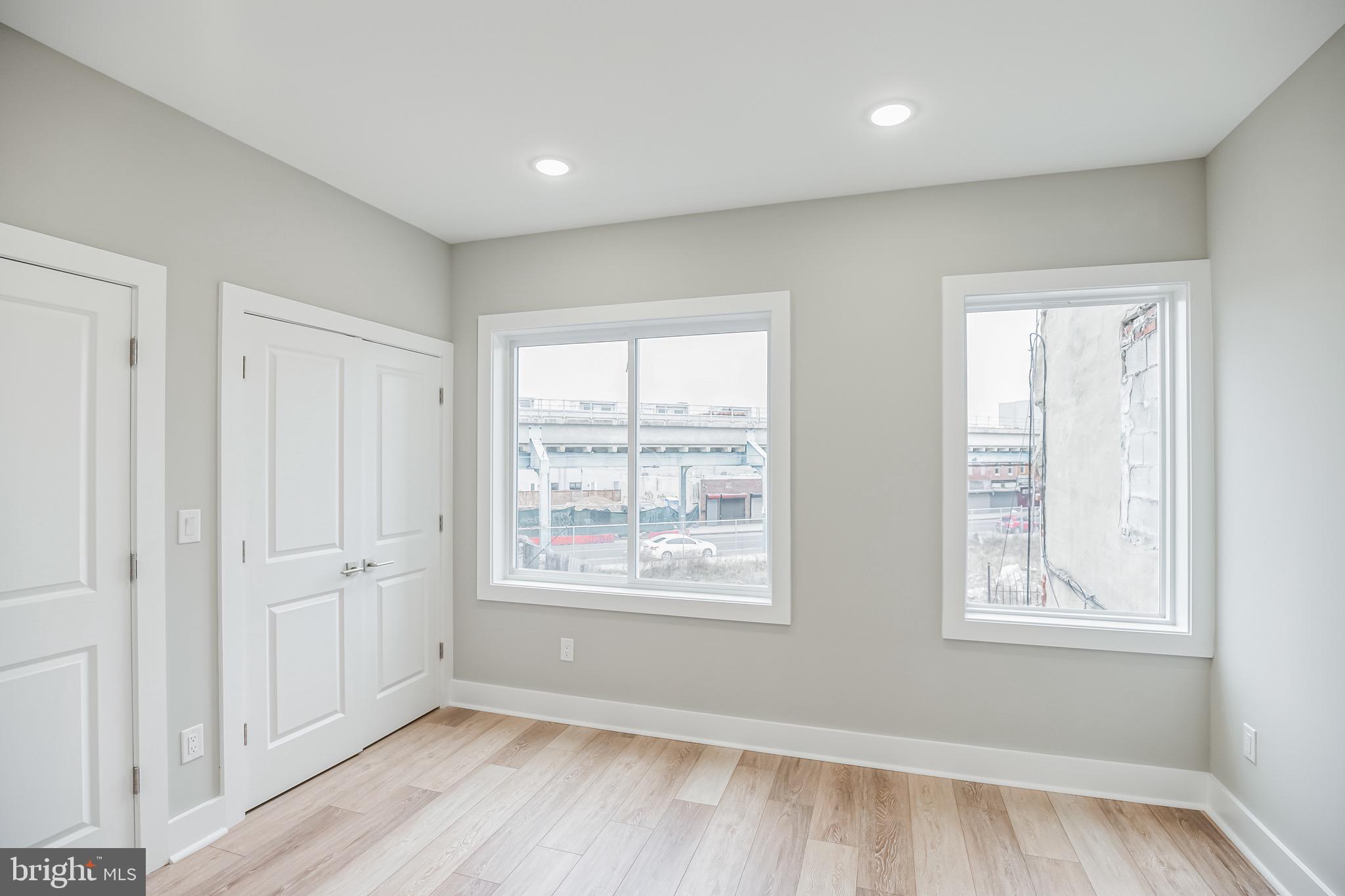 2216 Emerald Street, Unit B Philadelphia, PA 19125 - Photo 13 of 24 a view of an empty room with wooden floor and a window