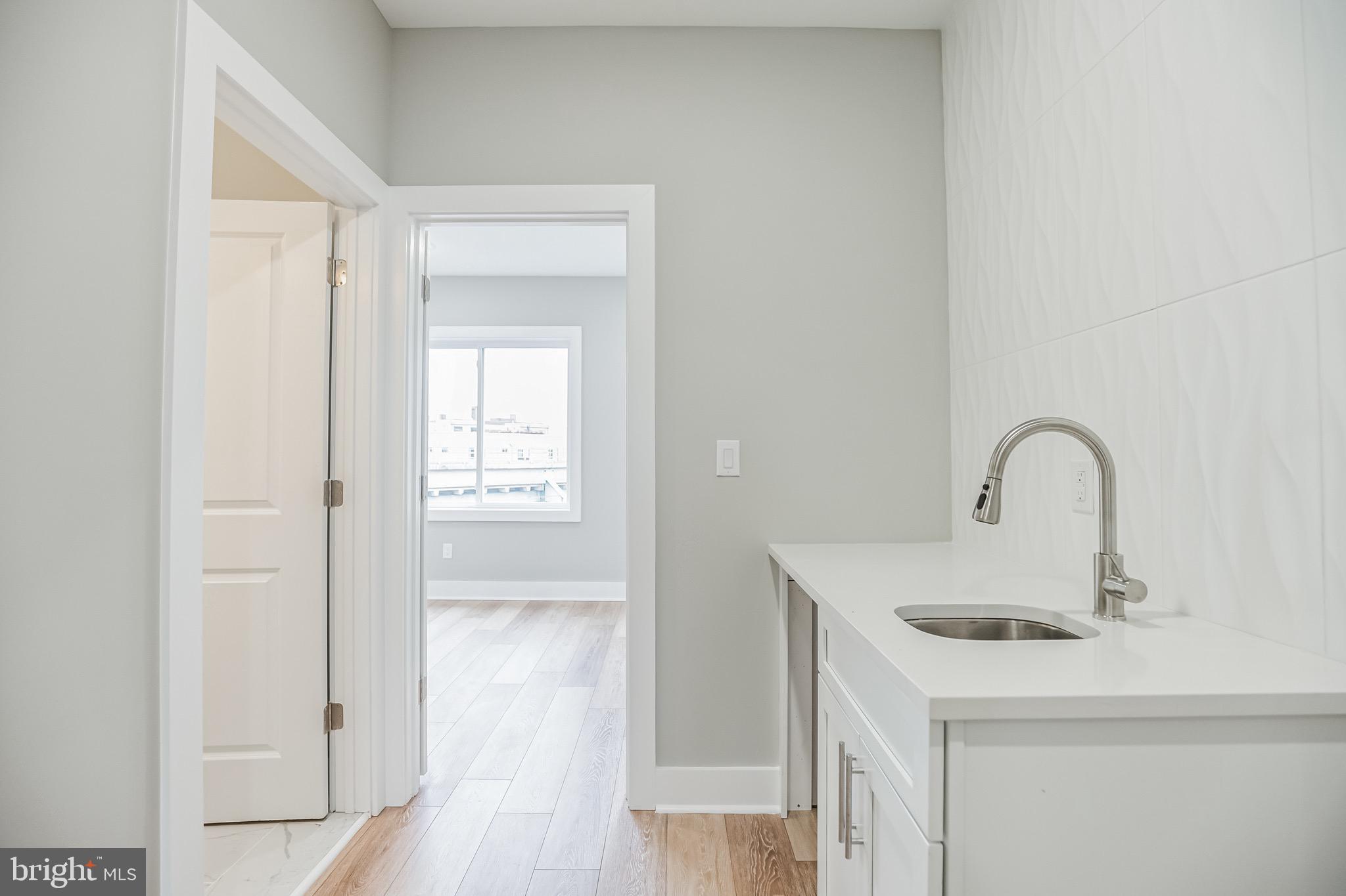 2216 Emerald Street, Unit B Philadelphia, PA 19125 - Photo 14 of 24 a kitchen with a sink and a refrigerator