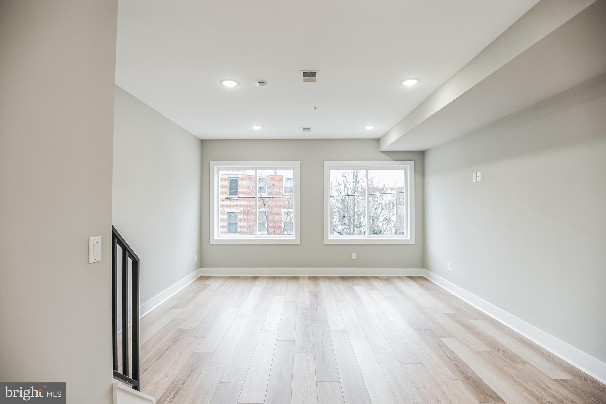 2216 Emerald Street, Unit B Philadelphia, PA 19125 - Photo 16 of 24 a view of an empty room with wooden floor and a window