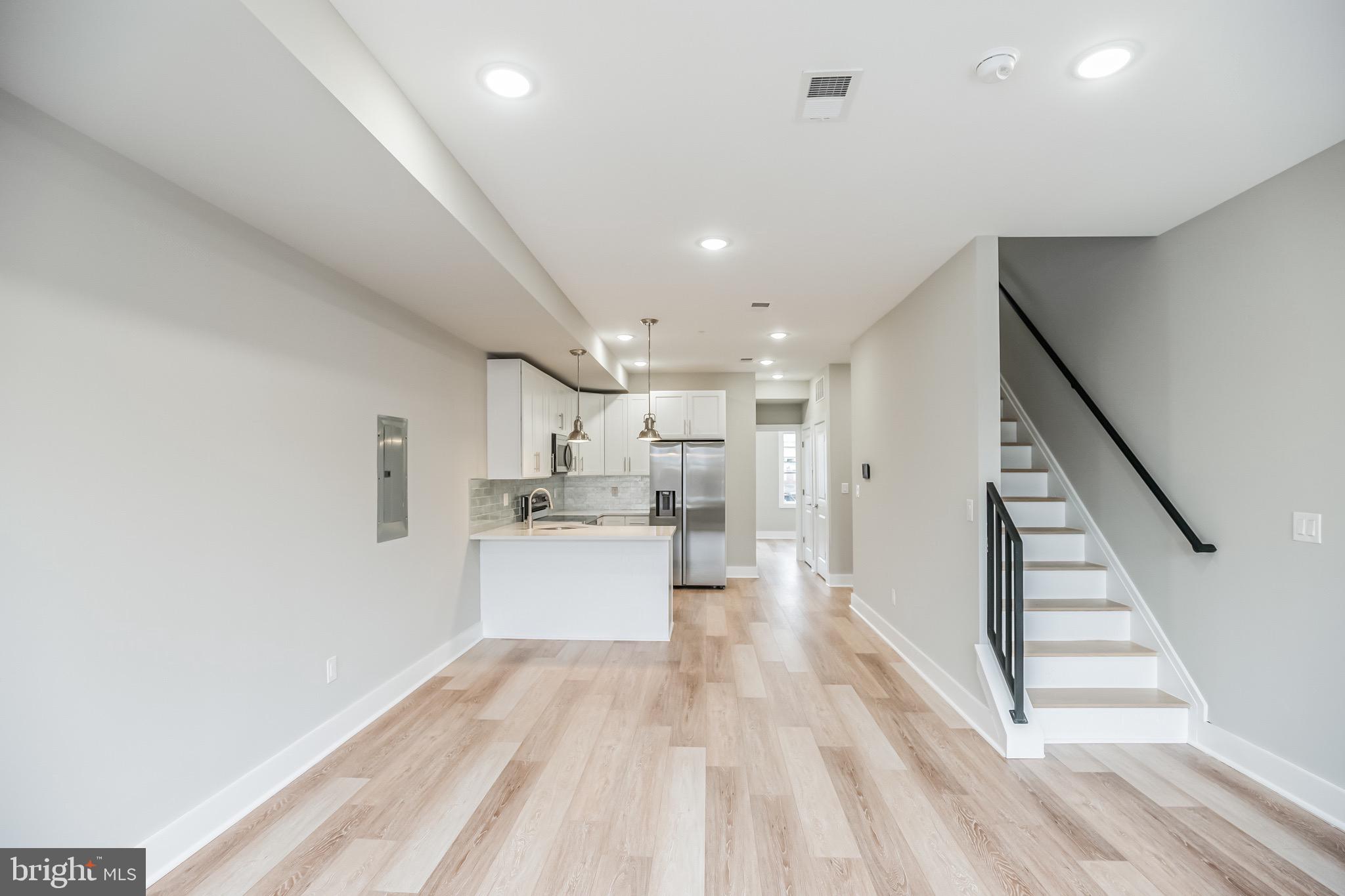 2216 Emerald Street, Unit B Philadelphia, PA 19125 - Photo 17 of 24 a view of a kitchen with wooden floor and electronic appliances