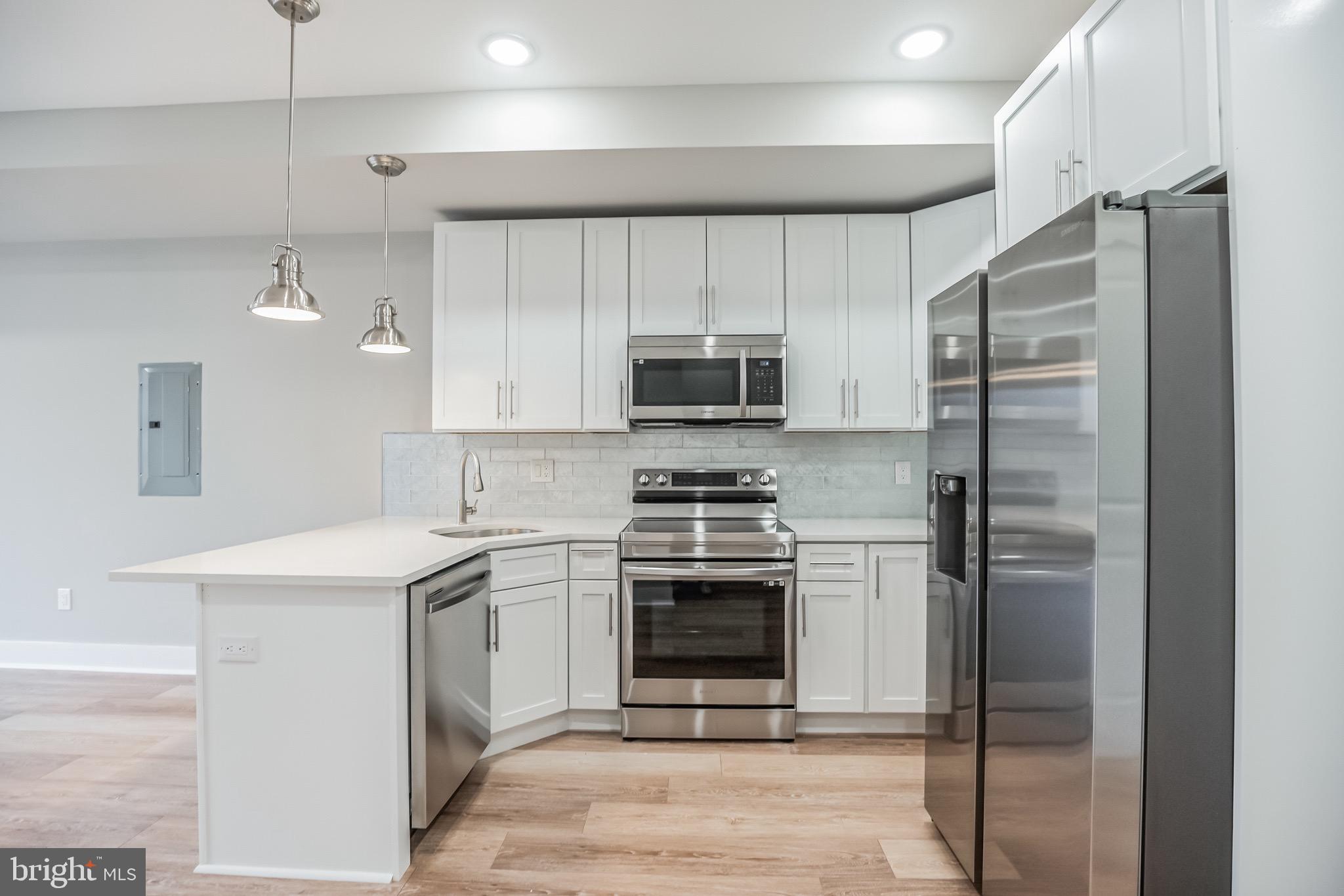 2216 Emerald Street, Unit B Philadelphia, PA 19125 - Photo 20 of 24 a kitchen with a sink stainless steel appliances and cabinets