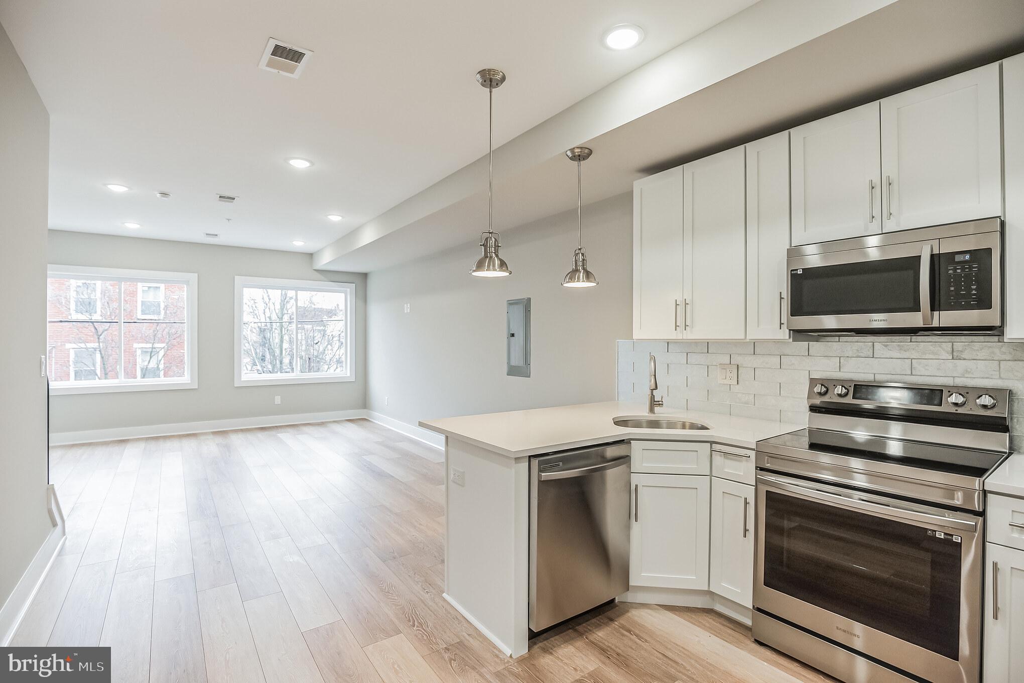 2216 Emerald Street, Unit B Philadelphia, PA 19125 - Photo 6 of 24 a kitchen with a stove oven and a sink