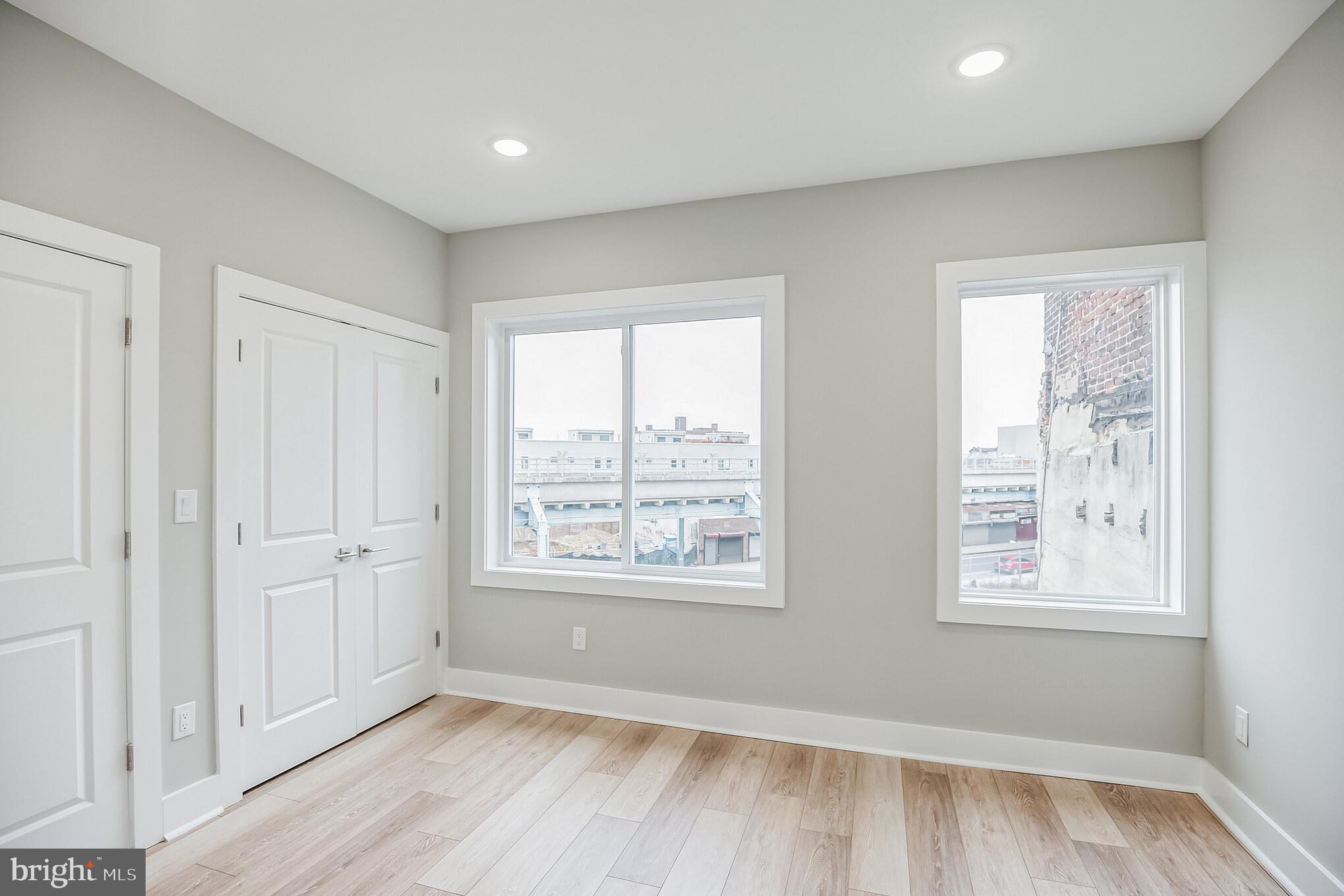 2216 Emerald Street, Unit B Philadelphia, PA 19125 - Photo 8 of 24 a view of an empty room with wooden floor and a window