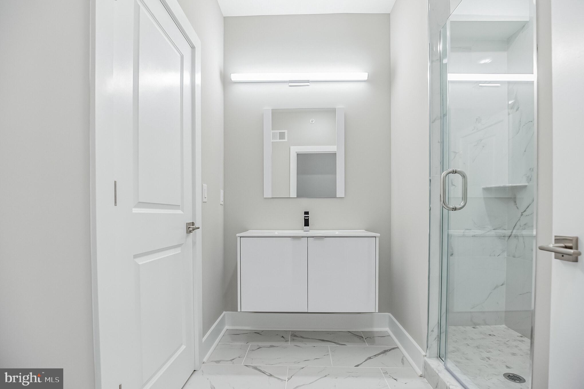 2216 Emerald Street, Unit B Philadelphia, PA 19125 - Photo 9 of 24 a bathroom with a sink and mirror