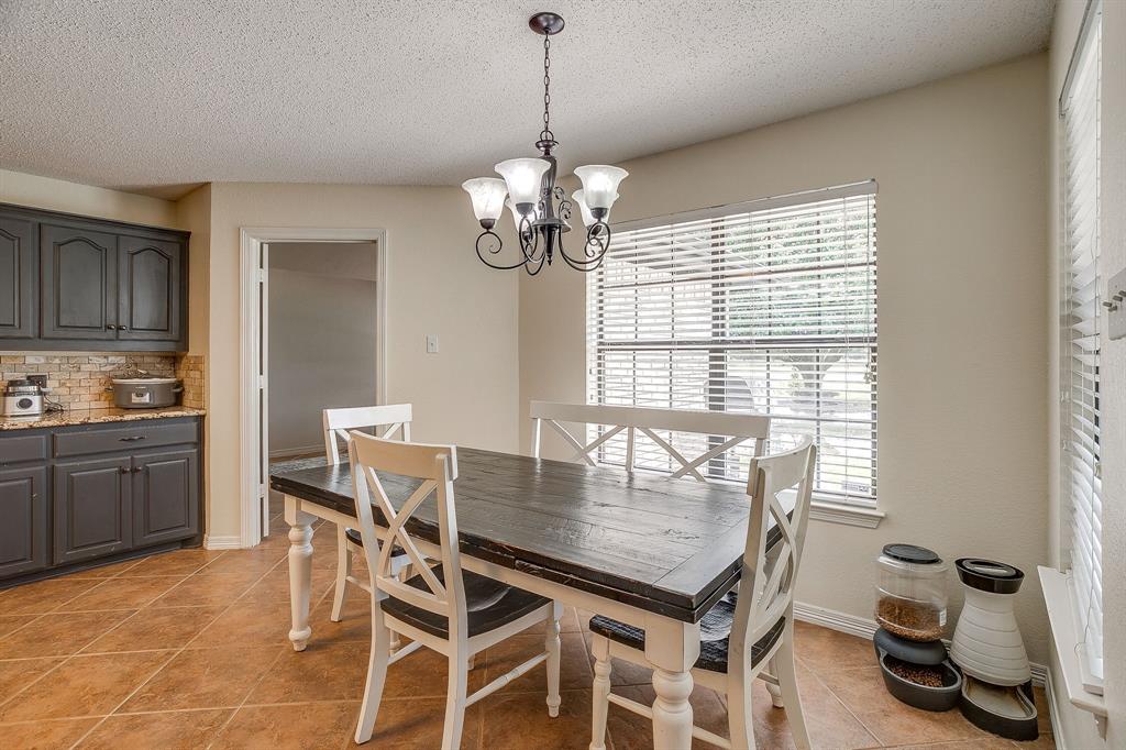 1050 Hampel Road Palmer, TX 75152 - Photo 12 of 35 a dining room with wooden floor a chandelier a wooden table and chairs