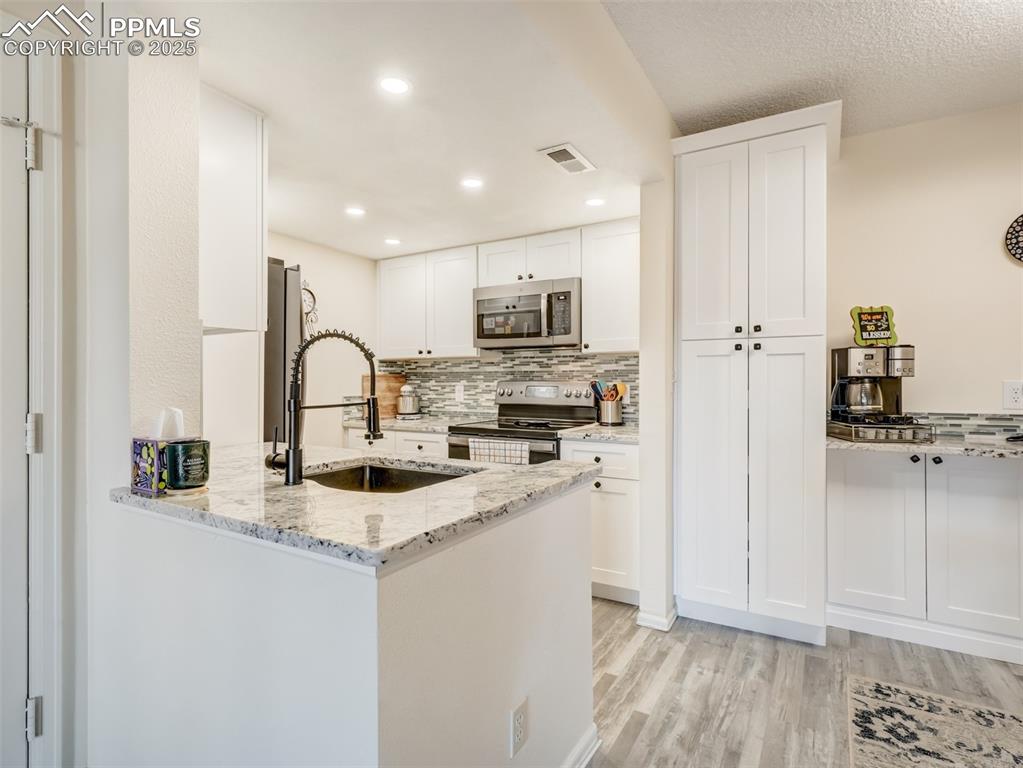 842 Tenderfoot Hill Road, Unit 1 Colorado Springs, CO 80906 - Photo 17 of 41 a kitchen with a refrigerator and a sink