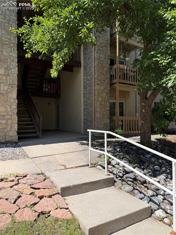 842 Tenderfoot Hill Road, Unit 1 Colorado Springs, CO 80906 - Photo 3 of 41 a view of a house with a tree and wooden fence