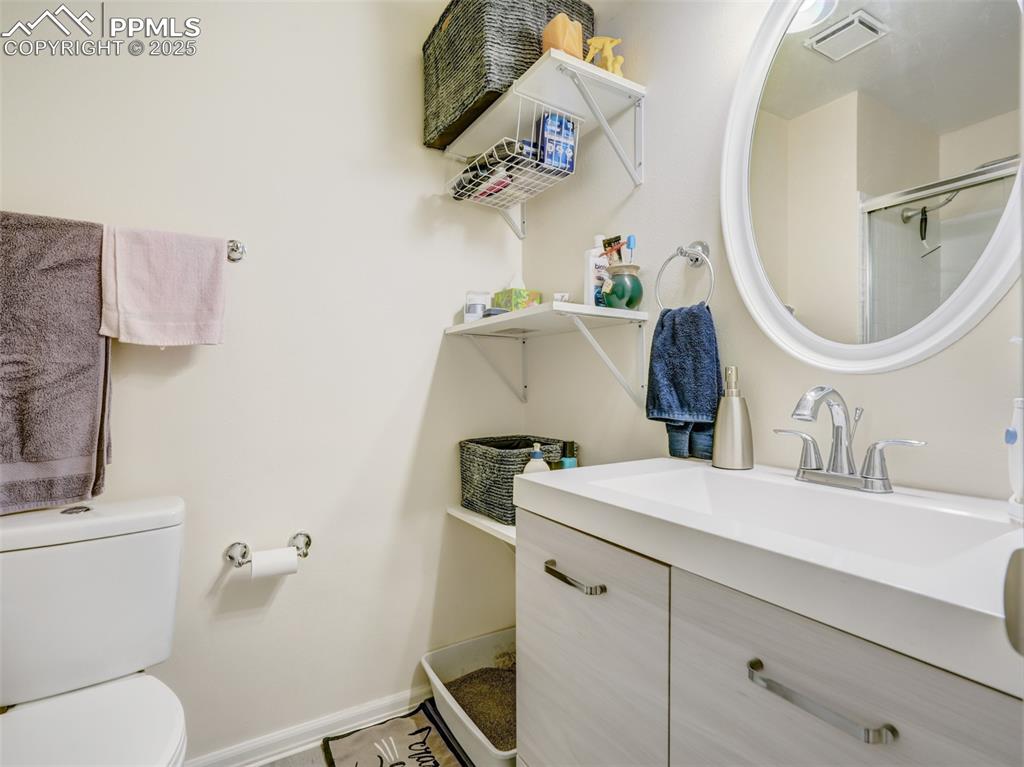 842 Tenderfoot Hill Road, Unit 1 Colorado Springs, CO 80906 - Photo 33 of 41 a bathroom with a sink vanity mirror and toilet