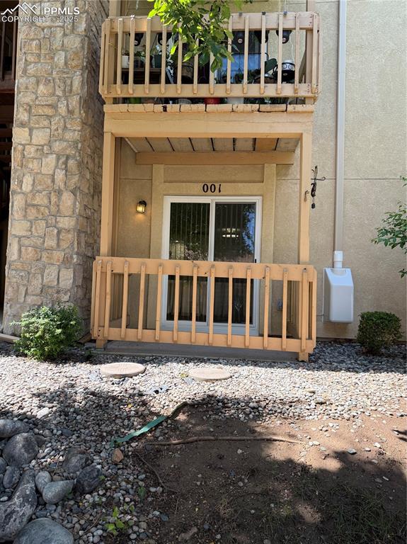 842 Tenderfoot Hill Road, Unit 1 Colorado Springs, CO 80906 - Photo 4 of 41 a front view of a building with a yard