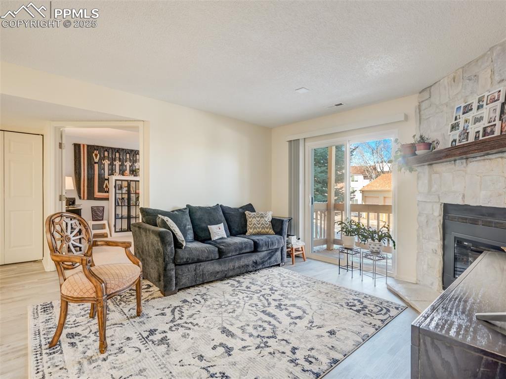 842 Tenderfoot Hill Road, Unit 1 Colorado Springs, CO 80906 - Photo 5 of 41 a living room with furniture windows and a fireplace