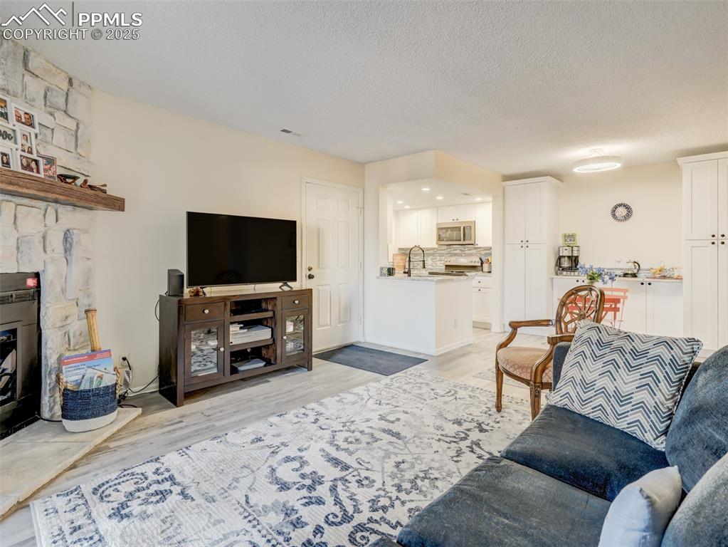 842 Tenderfoot Hill Road, Unit 1 Colorado Springs, CO 80906 - Photo 8 of 41 a living room with furniture and a flat screen tv