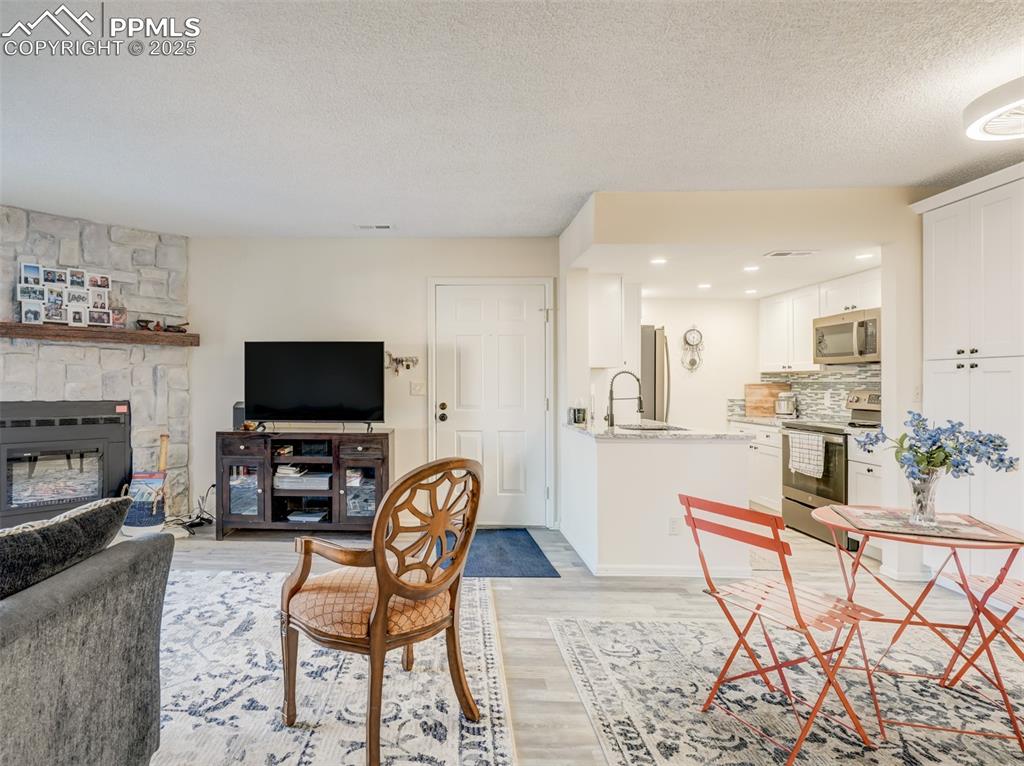 842 Tenderfoot Hill Road, Unit 1 Colorado Springs, CO 80906 - Photo 9 of 41 a living room with furniture and a flat screen tv