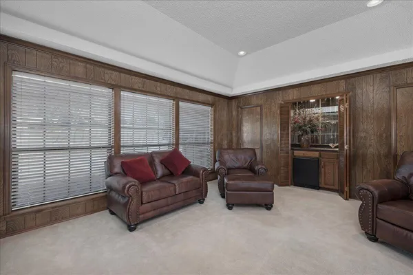 a living room with furniture and a floor to ceiling window