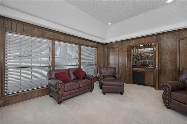 a living room with furniture and a floor to ceiling window