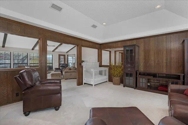 a living room with furniture gym equipment and a flat screen tv