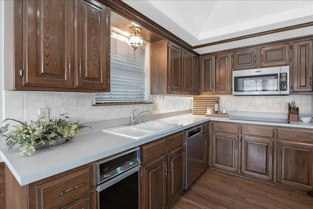 a kitchen with a sink cabinets and window