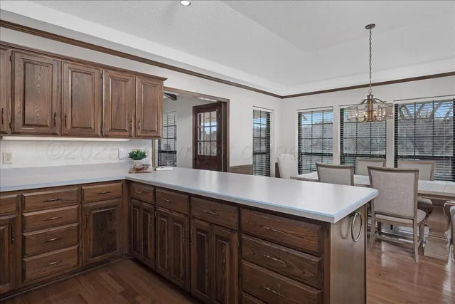 a kitchen with a sink cabinets and wooden floor
