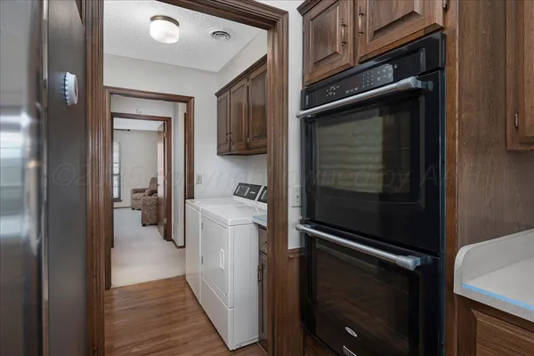 a kitchen with a refrigerator and cabinets