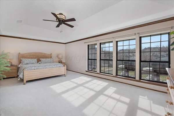 a room with a bed and a large window