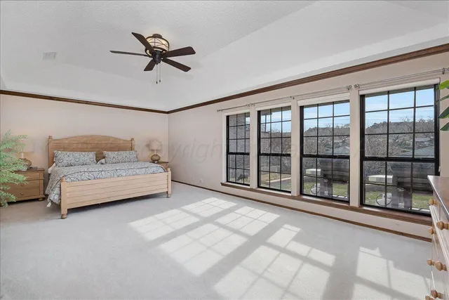 a room with a bed and a large window