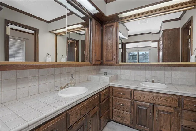 a bathroom with a sink and two mirror