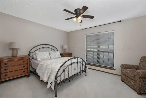 a bed room with a bed and a chandelier