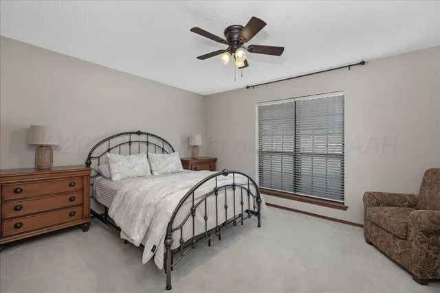 a bed room with a bed and a chandelier