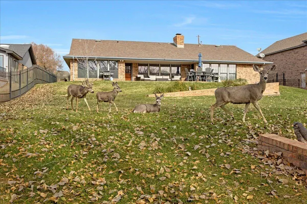 a front view of a house with swimming pool and patio