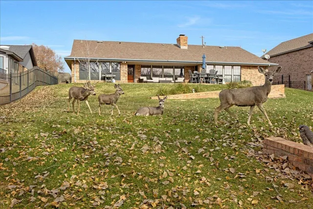 a front view of a house with swimming pool and patio