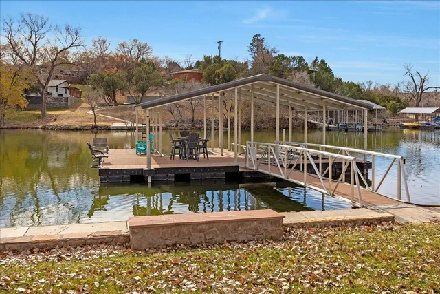 a view of a lake with boats and palm trees