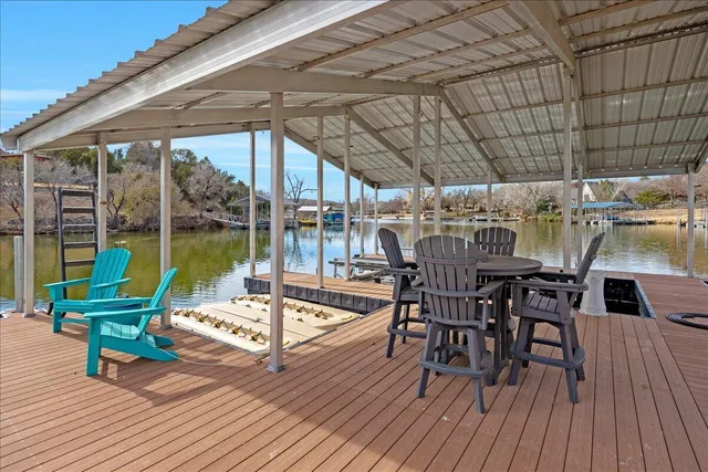 a view of a patio with table and chairs and wooden floor