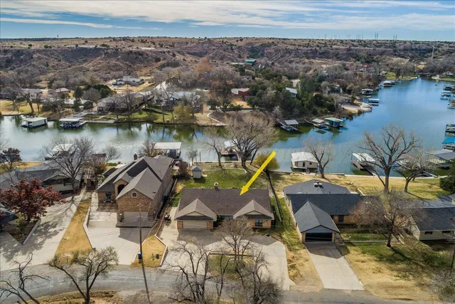an aerial view of a house with a lake view
