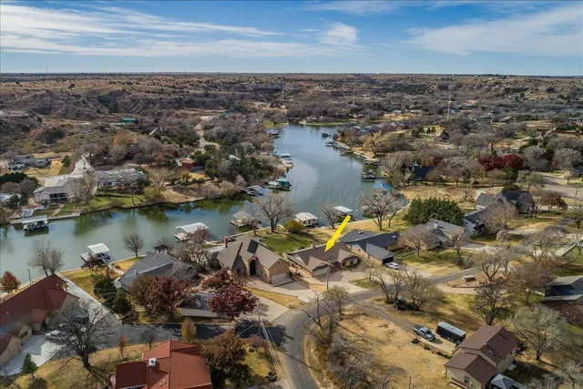 an aerial view of a house with a lake view