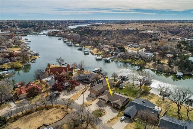 an aerial view of a houses with ocean view