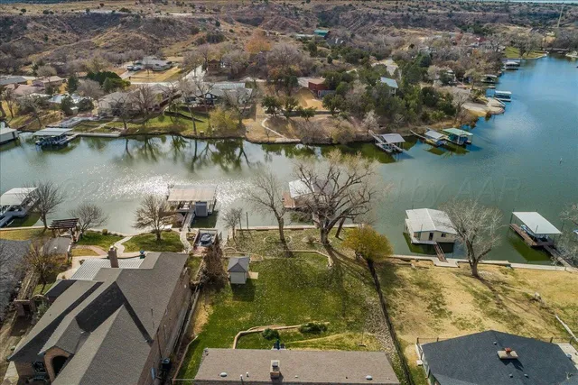 an aerial view of a house with a lake view
