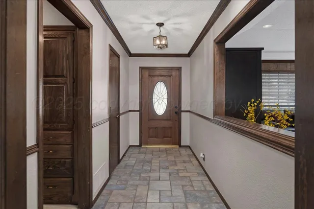 a hallway with painting and a large mirror