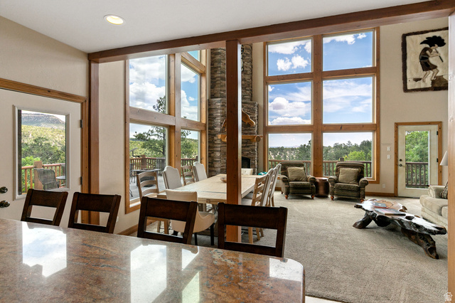 755 South Zion Ridge Drive Orderville, UT 84758 - Photo 44 of 84 Carpeted dining area featuring a high ceiling, a fireplace, and recessed lighting