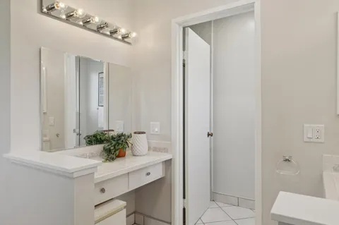 a bathroom with a sink vanity and shower