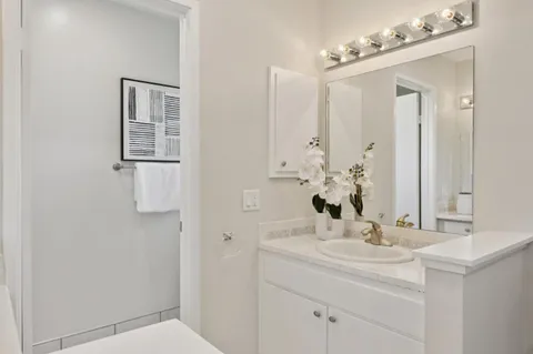 a bathroom with a sink vanity and a mirror