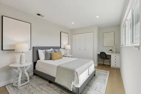 a bedroom with a bed and lamp