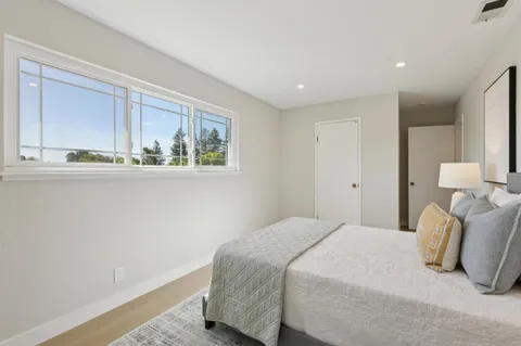 a bedroom with a bed and window