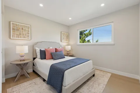 a bedroom with a bed and a painting on the wall